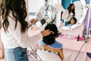 A woman is drying another woman’s hair in the salon - Darren Yaw Singapore